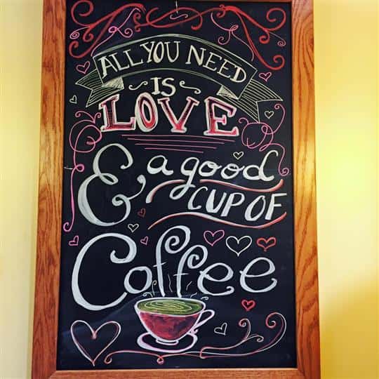 message on chalkboard that reads all you need is love and a good cup of coffee