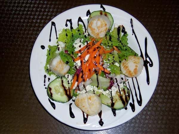 salad drizzled with dressing on a plate