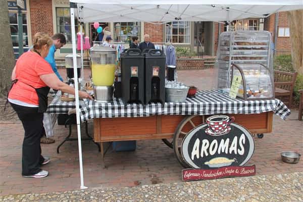 table set up outside with the aromas logo under it