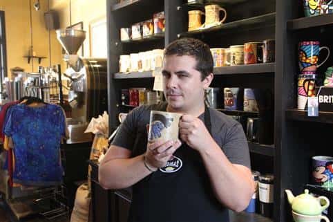 worker posing with coffee mug