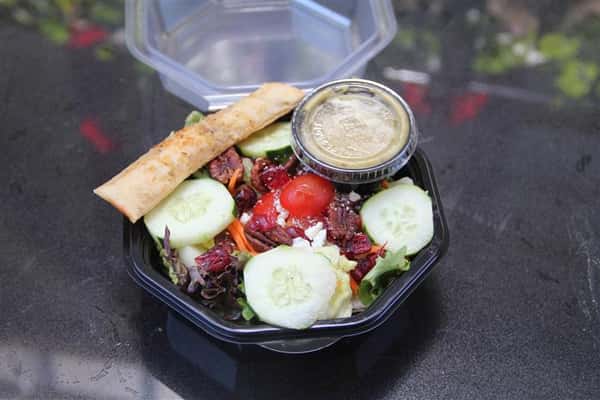 salad in container with dressing