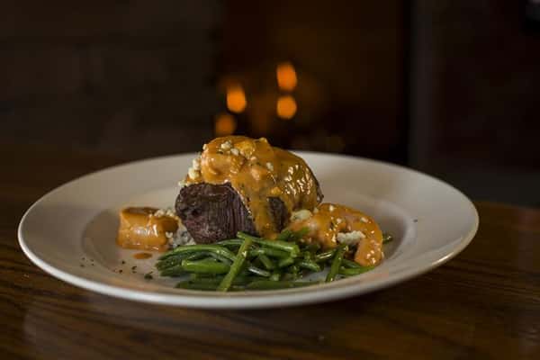 Grilled beef tenderloin and sauteed shrimp with Buffalo bleu cheese cream sauce served over red skinned mashed potatoes.