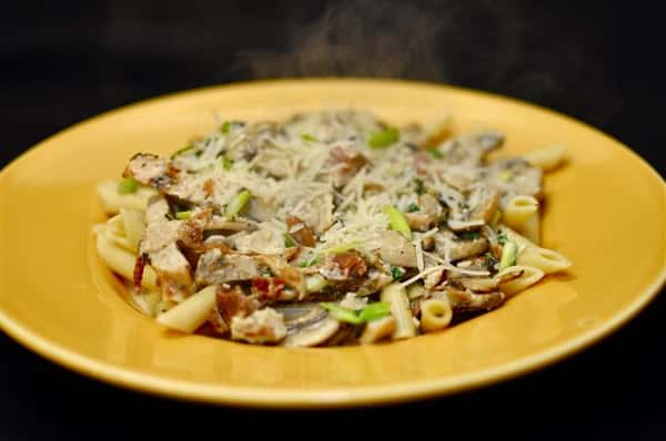 Penne pasta served with grilled chicken, mushrooms mixed in a creamy sauce.