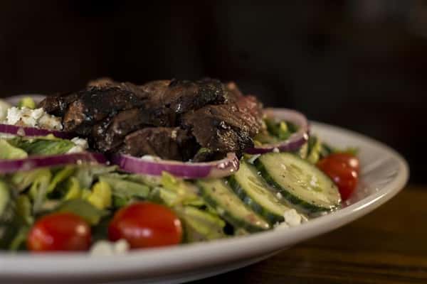 Donovan's Special salad, chopped romaine, with grilled hanger steak, red onions, tomato, blue cheese crumbles & roasted garlic red wine vinaigrette.