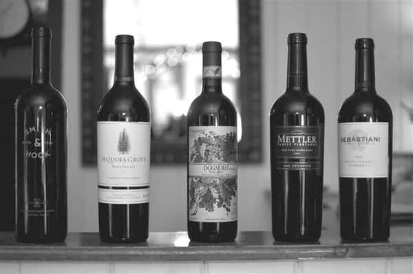 Black and white image of 5 bottles of wine.