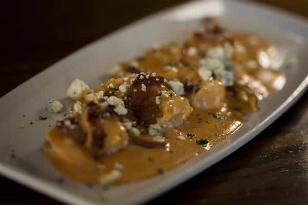 Buffalo Shrimp, Pan-seared shrimp in a buffalo bleu cheese and bacon cream sauce.