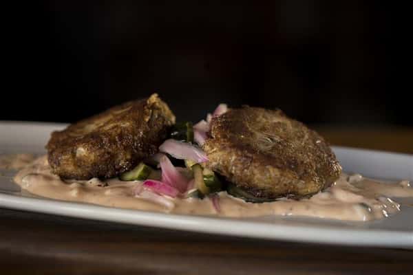 Sauteed Crab Cakes served with a cucumber relish and remoulade.