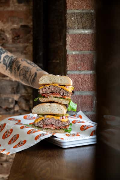 Side view of a towering double cheeseburger