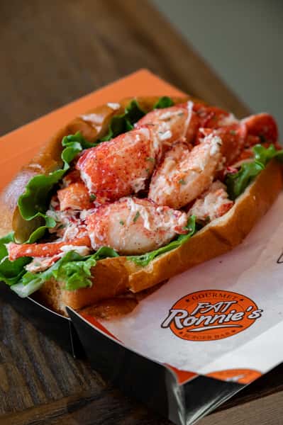 Lobster roll filled with fresh lobster meat in a toasted bun