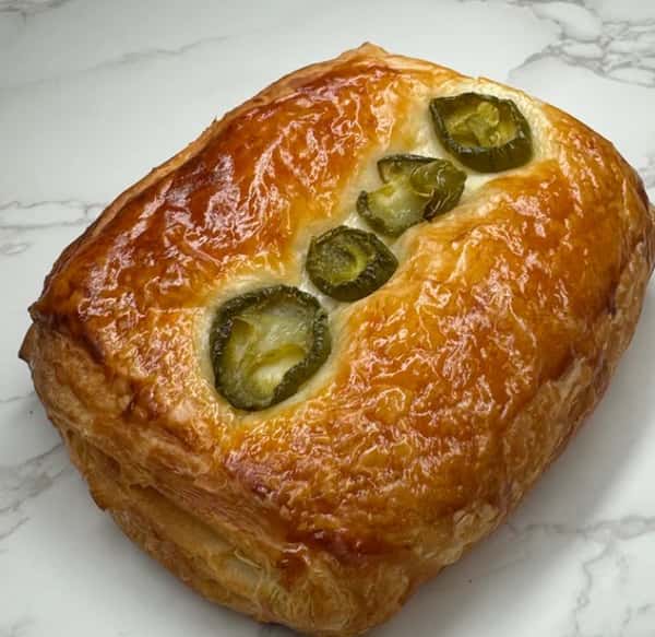 Golden, flaky pastry topped with sliced jalapeños baked into glossy puff pastry crust