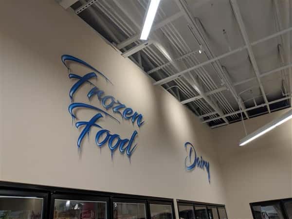 Frozen Food, Drinks signs on wall inside market
