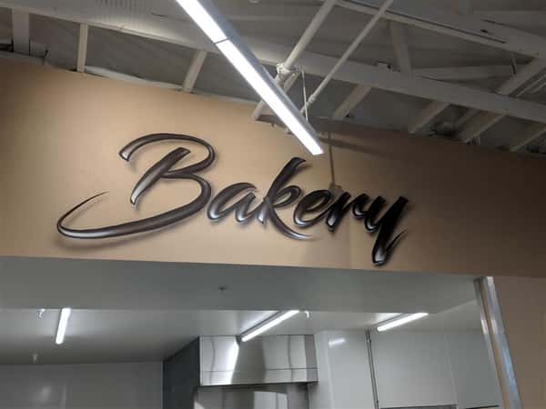 Bakery sign on wall inside market