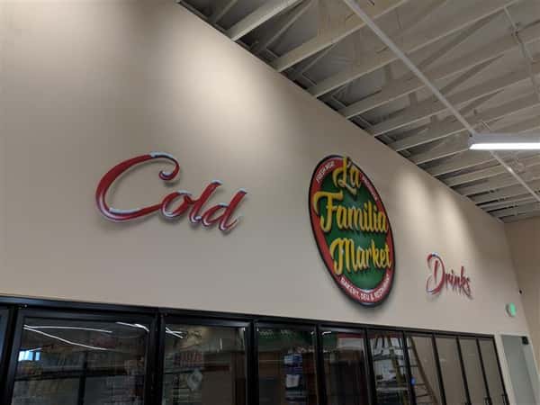 Cold Drinks and La Familia market on wall inside market