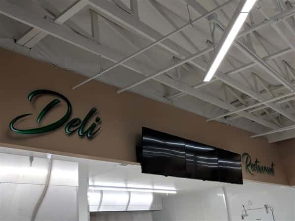 Deli sign on wall inside market