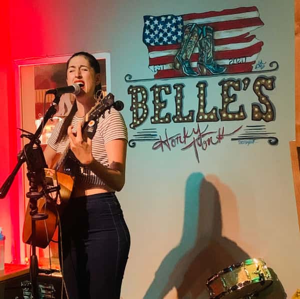 musician singing at Belle's