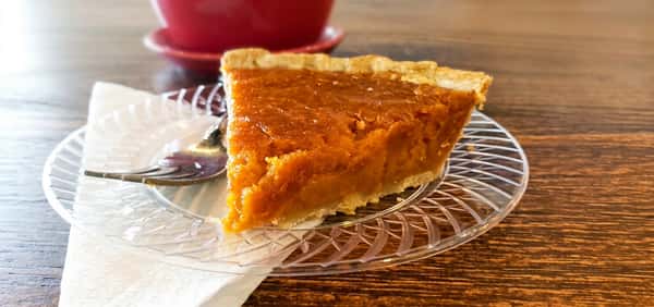 Slice of sweet potato pie with flaky crust at Fainmous BBQ Pearland TX