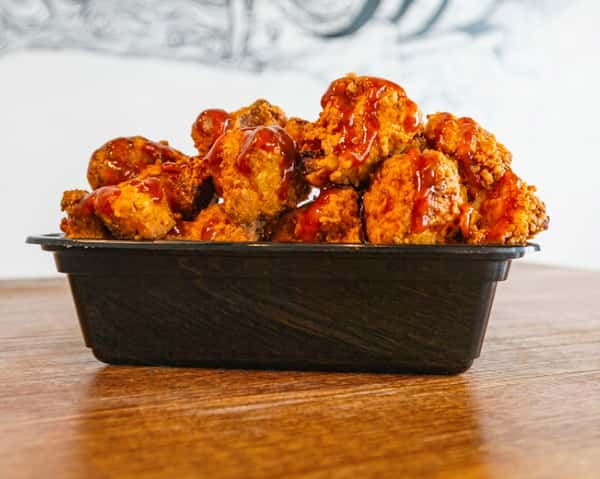 Boneless BBQ chicken wings tossed in sauce at Fainmous BBQ Pearland TX