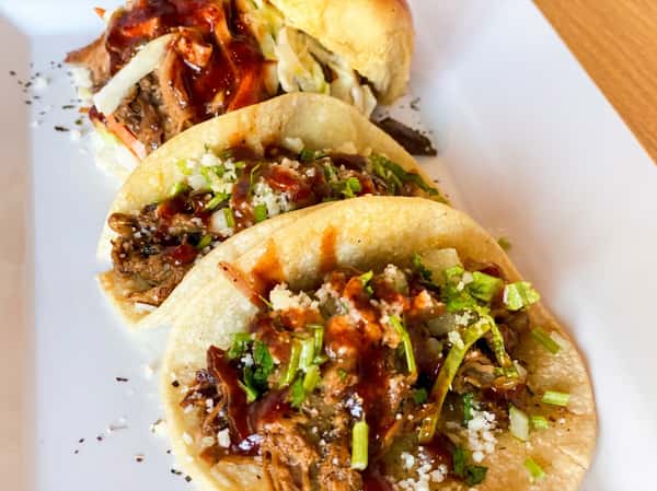 Pulled pork tacos with fresh toppings at Fainmous BBQ Pearland TX