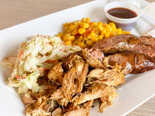 Pulled chicken and smoked sausage plate with sides at Fainmous BBQ in Pearland TX