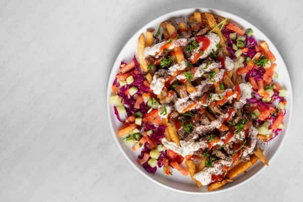 Top down view of Beef Shawarma Fries on a white plate