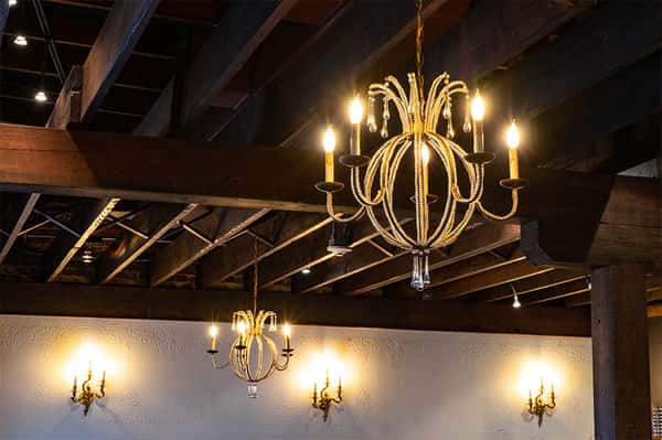 ceiling with chandeliers and exposed beams