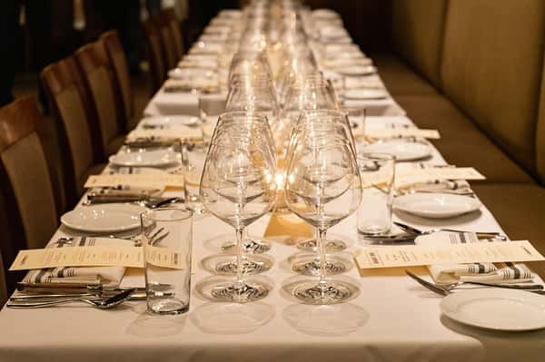 table with wine glasses set for formal event
