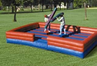 two kids wrestling over an inflatable area