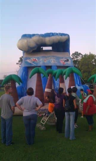 a bounce house with inflatable palm trees and clouds