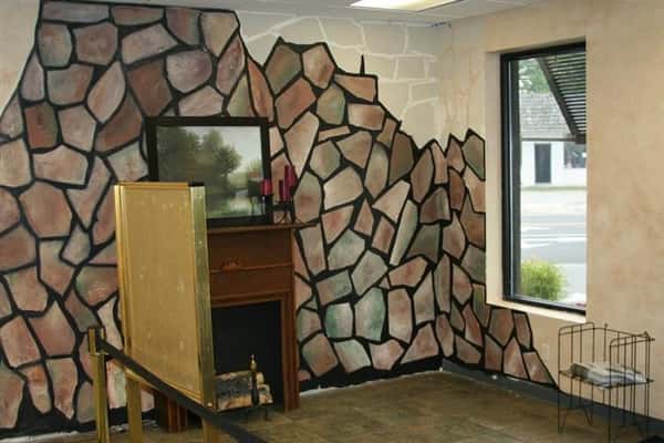 indoor fireplace with stone wall