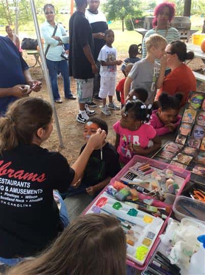 a little girl getting her face painted