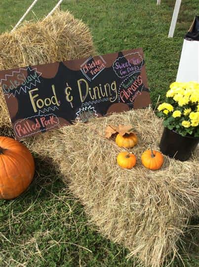 a hay bale with a sign that says "Food & dining" on it with pumpkins
