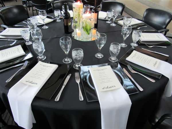 table setting for formal event with candles as the centerpiece