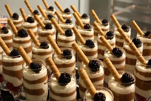 Mini dessert pots topped with blackberries and wafer sticks