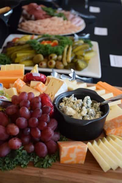 board with sliced cheese and grapes