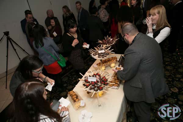 guests grabbing dessert from a table