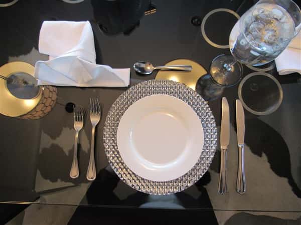 Full serving set of plate with utensils and glassware