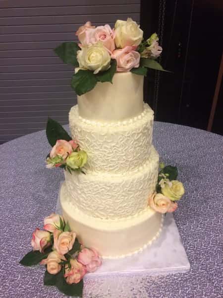 wedding cake with fresh pink roses