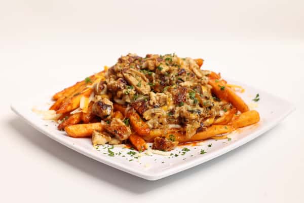 Fries, cheese, and savory toppings cover a white square plate. The dish is displayed on a clean background as part of a website gallery.
