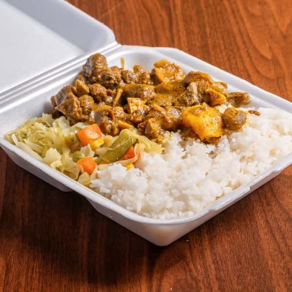 Curried chickpeas and potatoes served over rice with coleslaw