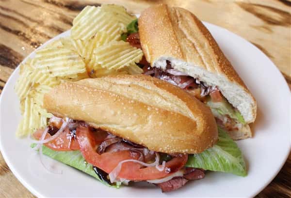 Turkey & Roast Beef Hoagie. Smoked turkey and roast beef, provolone cheese topped with bacon served on a toasted hoagie with mayo, green leaf lettuce and red onion with side of chips.