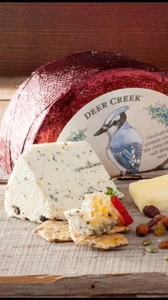 We want to take a minute to introduce you to one of our newer Home Grown partners, Sheboygan Wisconsin’s Deer Creek Cheese.
Deer Creek’s cheeses are a family’s kitchen counter creations come to life at the hands of some of Wisconsin’s greatest Master Cheesemakers. The brand collaborates to create cheeses that are characterful, inspiring both the cheese lover and cheese professional with whimsical personality, creative flavor, and consistent quality. With the help of his family and team, founder Chris Gentine strives to showcase some of the best of what The Dairy State has to offer by blending traditional, sustainable cheesemaking methods with a unique cocktail of cultures and ingredients, and a rigorous cheese grading program. This collection of handmade and hand selected Wisconsin artisan and specialty cheeses blends time-honored traditions with new sensory experiences.
Deer Creek is focused on taking steps to help protect our planet and its people. That’s why they commit 1% of their annual gross sales to support environmental nonprofits, partner with local businesses, and continuously make choices that have a positive impact on Mother Earth.