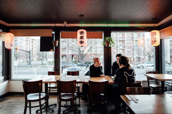 Interior of a Japanese-style ramen restaurant with hanging lanterns