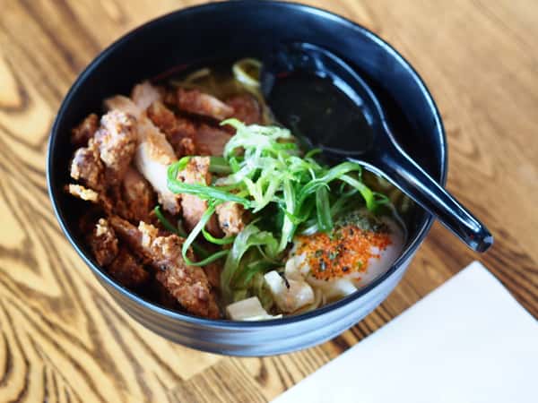 Bowl of ramen with fried chicken, scallions, and seasoned soft egg