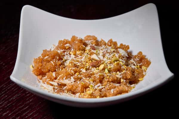 Gajar halwa carrot dessert garnished with nuts and coconut flakes