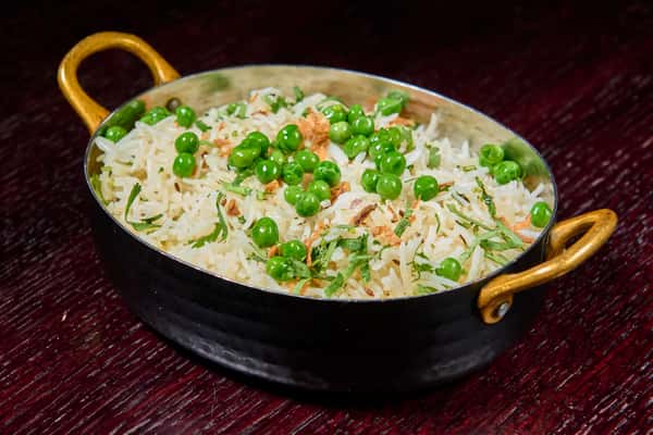 Peas pulao basmati rice with green peas and herbs in a serving dish