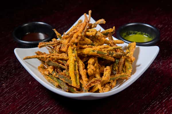 Crispy fried okra appetizer served with dipping sauces
