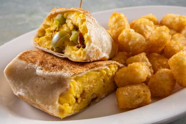 Breakfast burrito filled with scrambled eggs, cheese, and peppers, served with a side of crispy tater tots.
