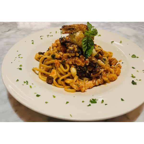 mixed sea food with marinara cappers olives topped with grilled shrimps