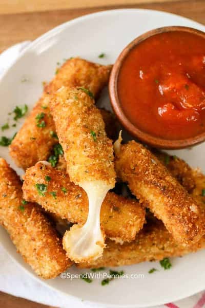 Crispy breaded mozzarella sticks with melted cheese pull, served with marinara dipping sauce.