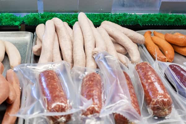 fresh sausages and vacuum-sealed meats displayed in deli case at G&W Sandwiches